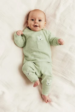 Baby green knitted leggings with rabbit appliqué