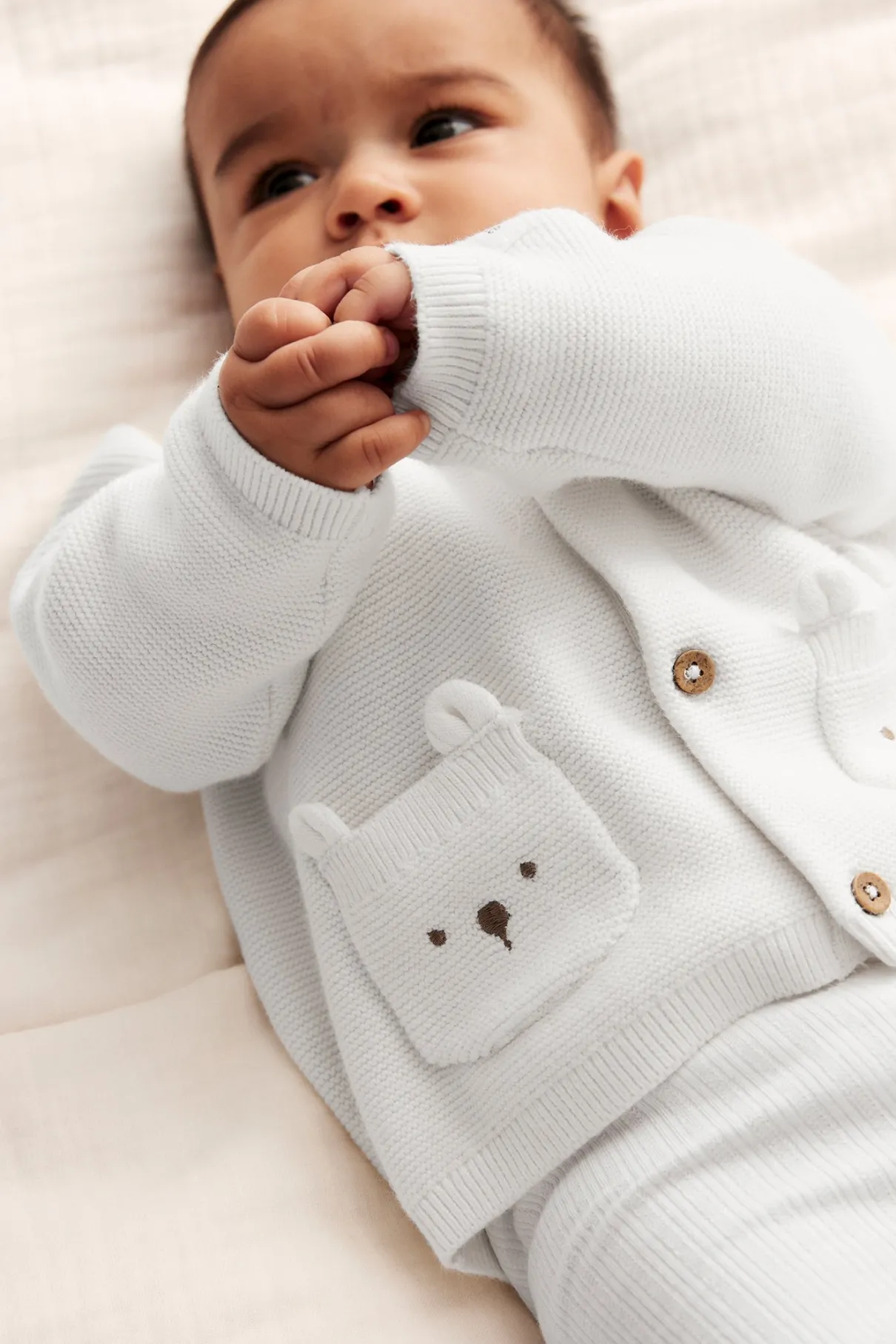 Baby white cardigan with cute pockets