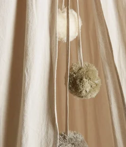 Beige reading tent with pom poms