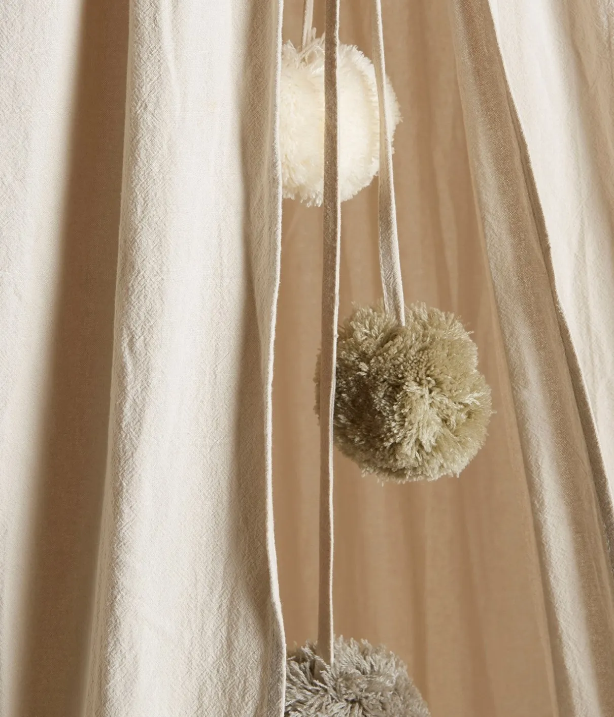 Beige reading tent with pom poms