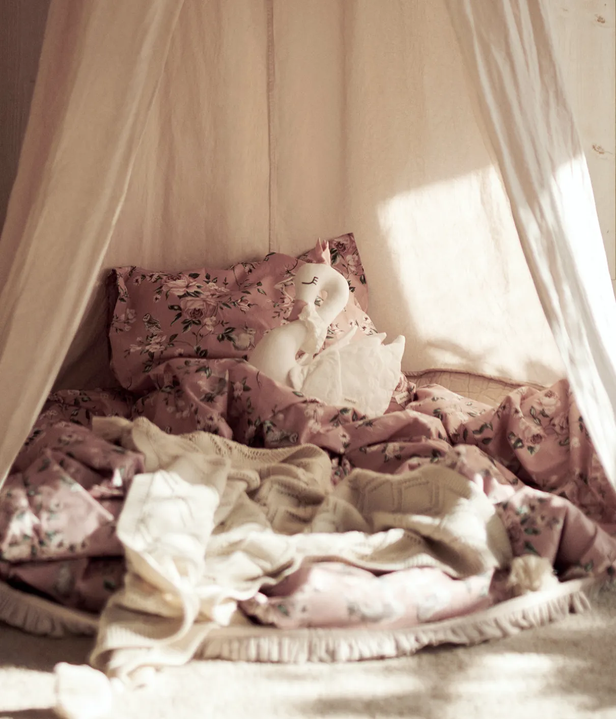 Beige reading tent with pom poms