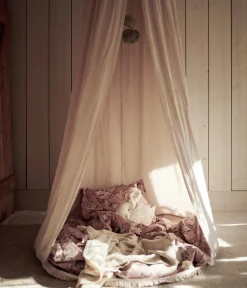 Beige reading tent with pom poms