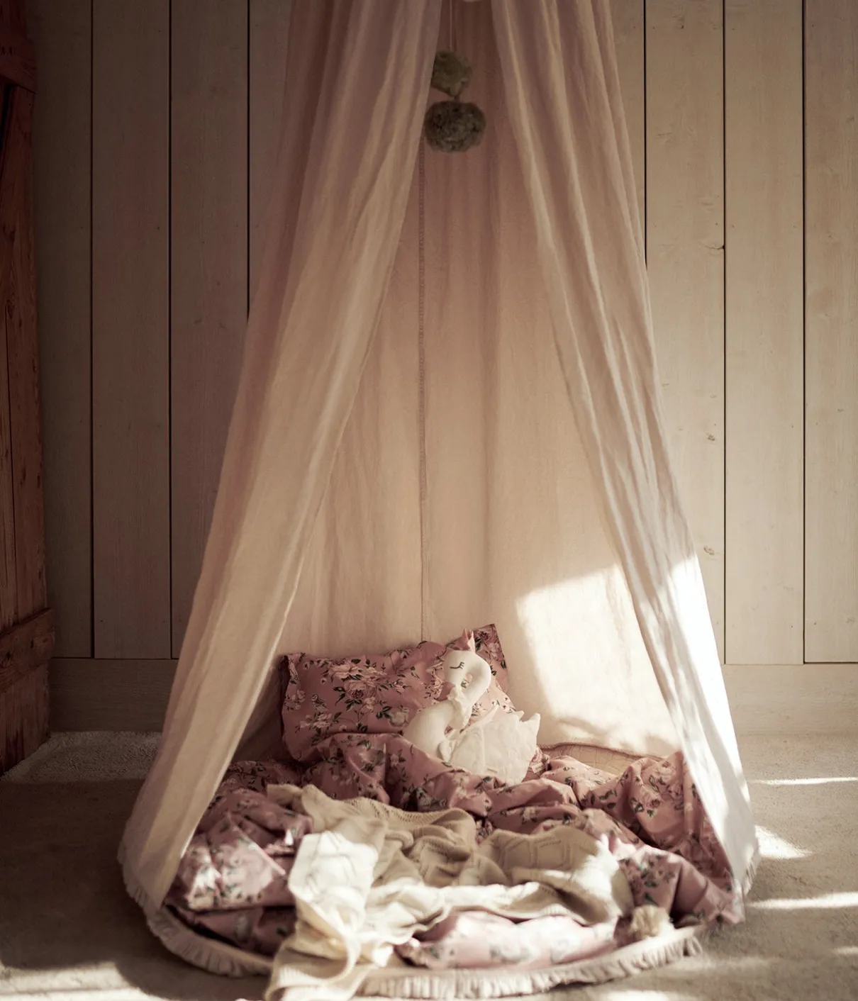 Beige reading tent with pom poms