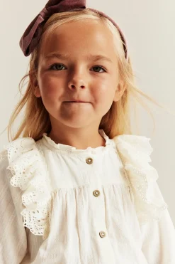 Kids' white blouse with embroidered frills