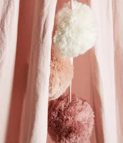 Pink reading tent with pom-poms